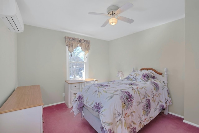 bedroom with a wall unit AC, carpet, baseboards, and a ceiling fan