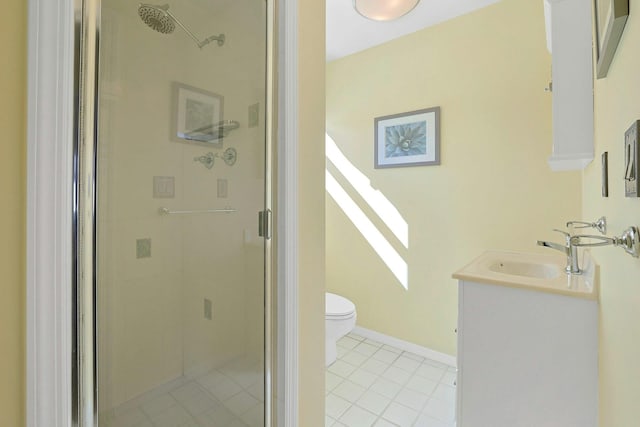 bathroom featuring baseboards, toilet, tile patterned flooring, vanity, and a shower stall