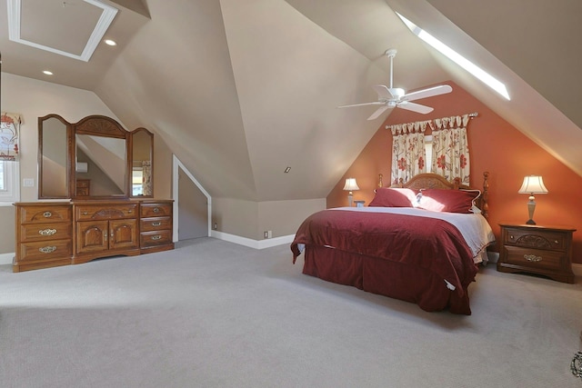 bedroom featuring recessed lighting, light colored carpet, vaulted ceiling with skylight, and baseboards