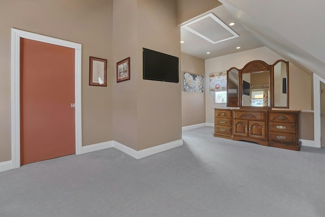 bedroom featuring light carpet, vaulted ceiling, and baseboards