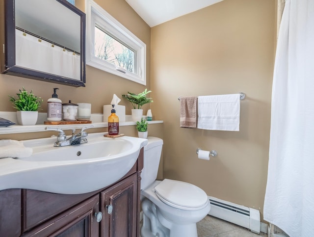 full bath featuring a baseboard heating unit, tile patterned flooring, vanity, and toilet