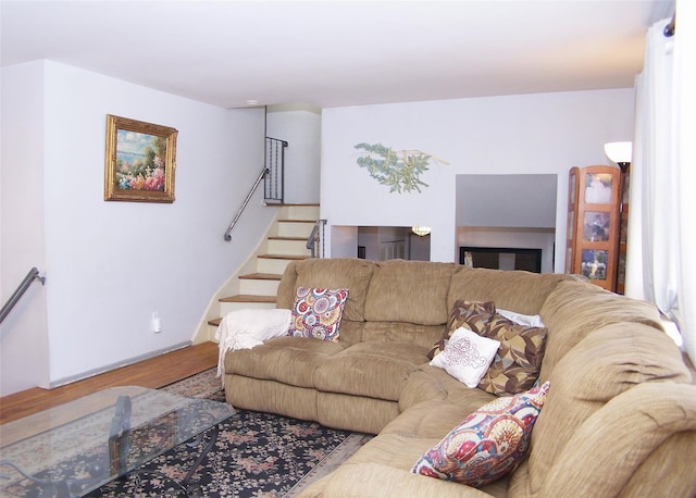 living room with stairway and wood finished floors