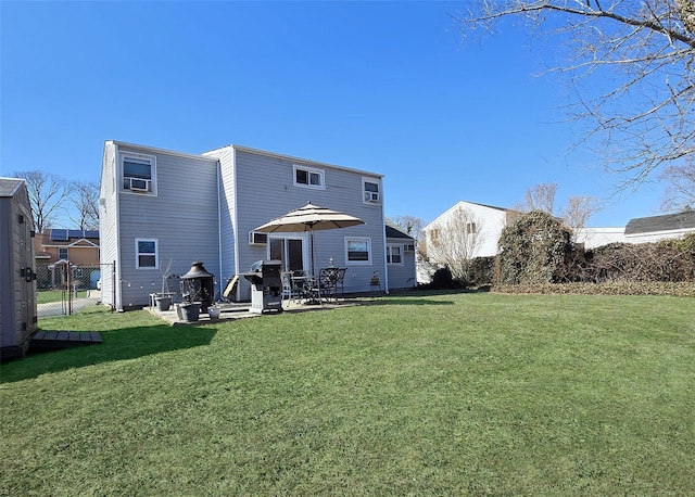 back of house with a patio, a lawn, fence, and a gate