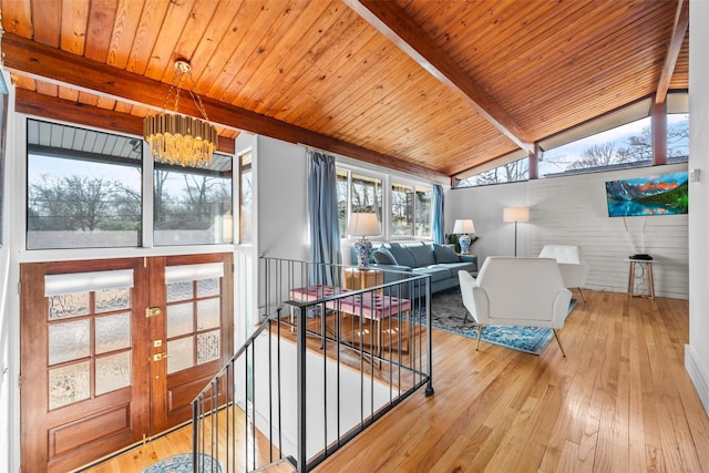 living room with lofted ceiling with beams, french doors, hardwood / wood-style floors, and wood ceiling