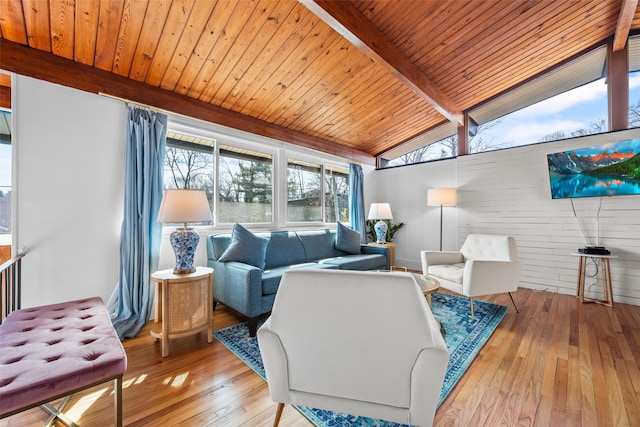 living area with vaulted ceiling with beams, hardwood / wood-style flooring, and wood ceiling