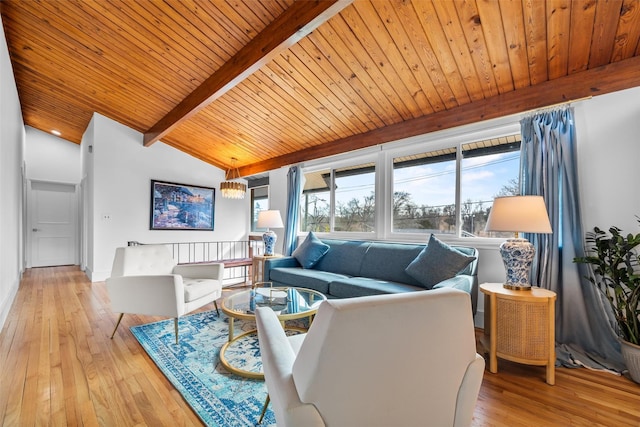 living area featuring beamed ceiling, wood-type flooring, wooden ceiling, and a notable chandelier