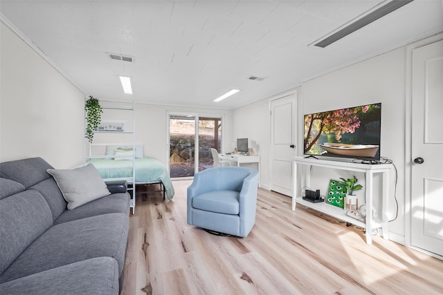 living area with light wood finished floors and visible vents