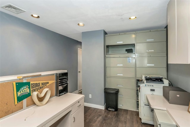 office area with dark wood-type flooring, recessed lighting, visible vents, and baseboards