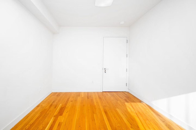 unfurnished room with wood finished floors