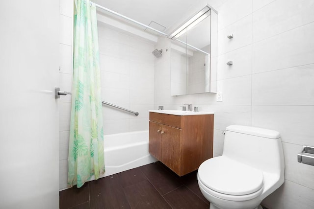 full bathroom featuring toilet, wood finished floors, tile walls, and shower / bathtub combination with curtain