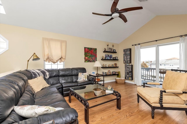 living room featuring lofted ceiling, light wood finished floors, ceiling fan, and baseboards