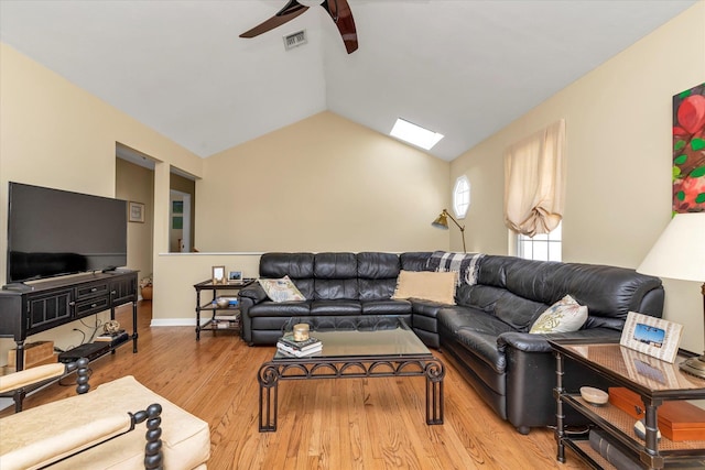 living room with baseboards, visible vents, a ceiling fan, vaulted ceiling, and light wood-type flooring