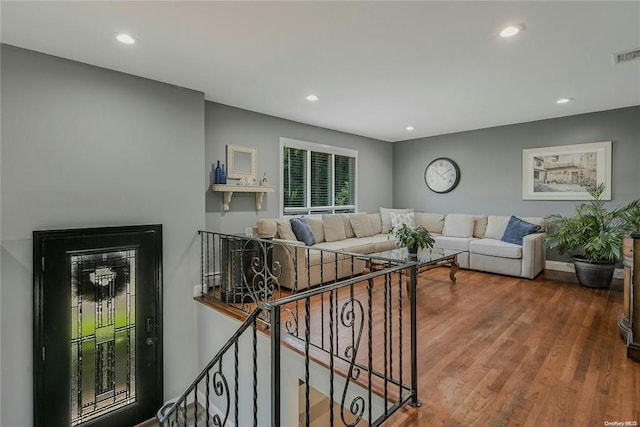 living area featuring recessed lighting, visible vents, baseboards, and wood finished floors