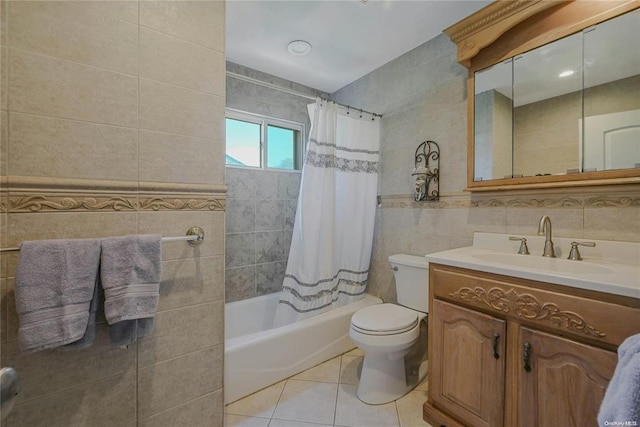 bathroom featuring tile patterned flooring, toilet, vanity, tile walls, and shower / bathtub combination with curtain