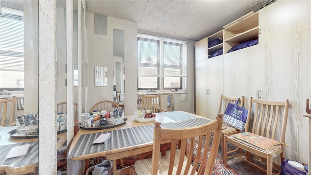 dining space with a textured ceiling