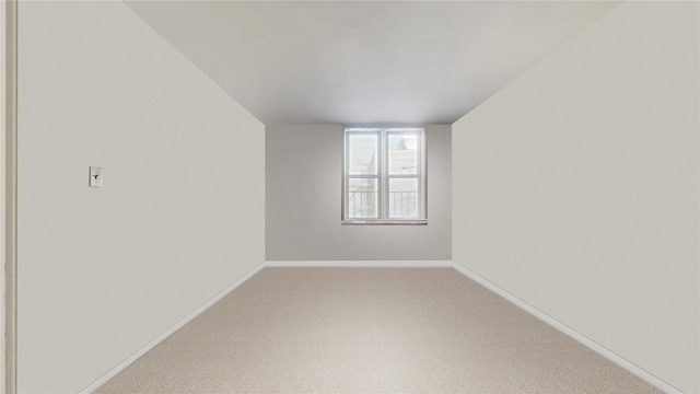 empty room with carpet and baseboards