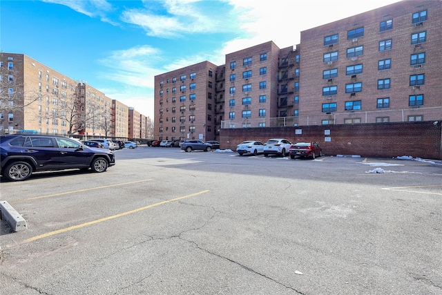 view of property with a view of city and uncovered parking