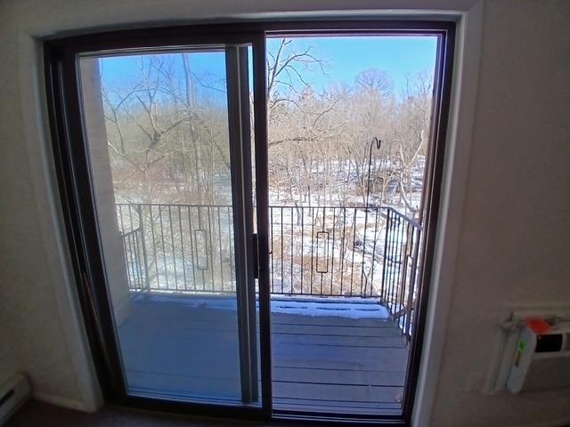 entryway with a baseboard heating unit and a wealth of natural light