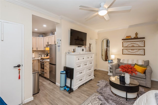 living area with baseboards, light wood finished floors, and crown molding