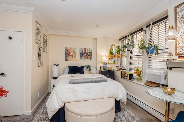 bedroom featuring a baseboard radiator, baseboards, crown molding, and wood finished floors