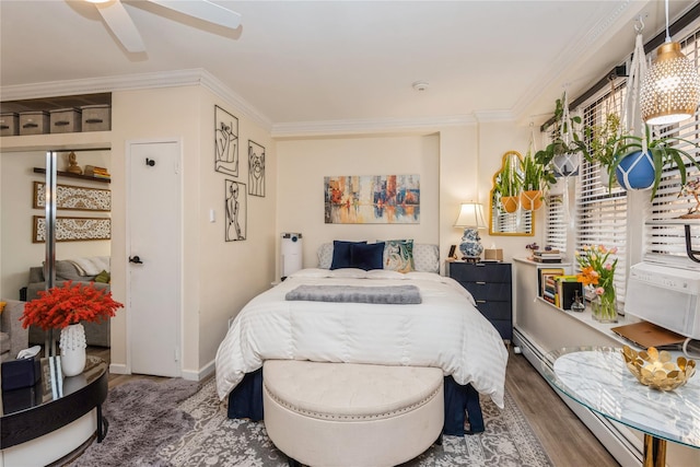 bedroom with ornamental molding, a ceiling fan, baseboards, and wood finished floors