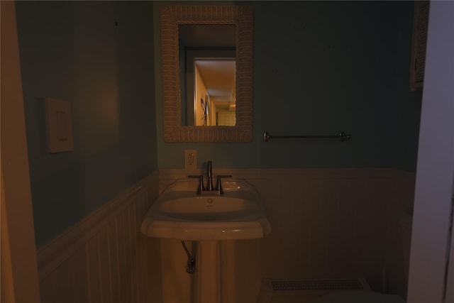 bathroom with a wainscoted wall