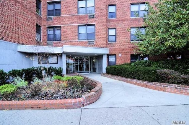 property entrance featuring brick siding