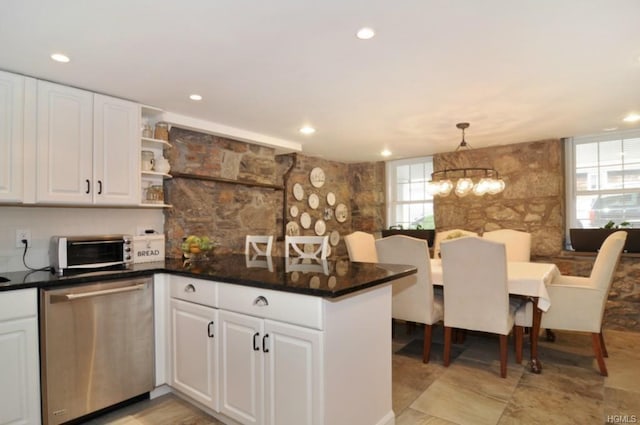 kitchen with white cabinets, dark countertops, a peninsula, open shelves, and stainless steel dishwasher