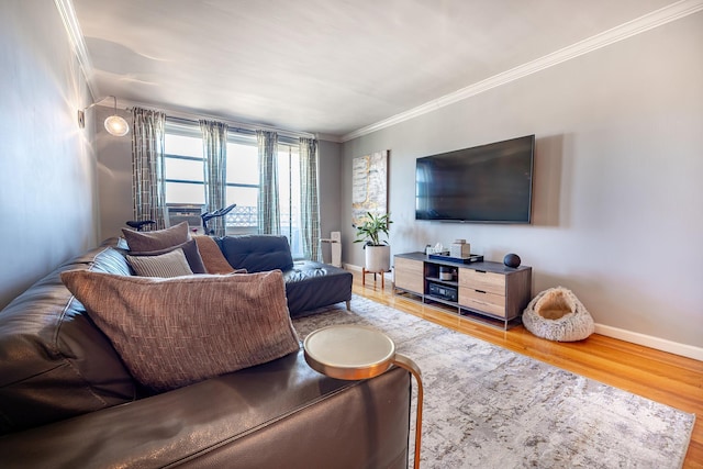 living room featuring baseboards, wood finished floors, and crown molding