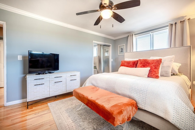 bedroom featuring ceiling fan, ornamental molding, light wood-style flooring, and baseboards