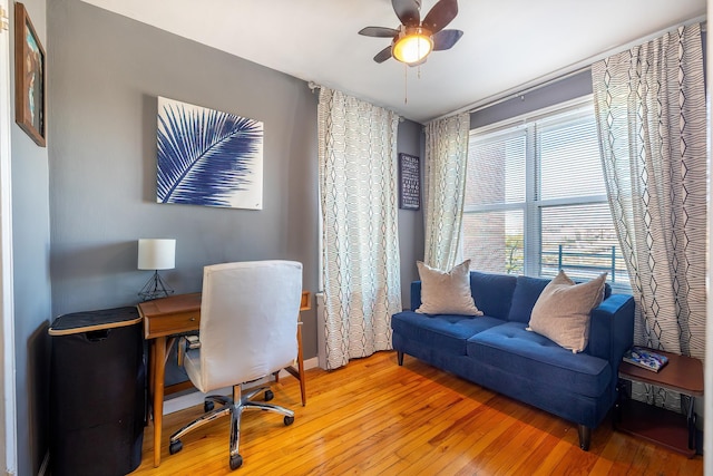 home office with ceiling fan and wood finished floors