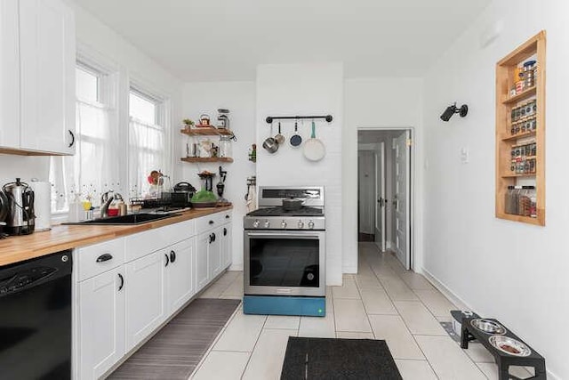 kitchen with a sink, wood counters, white cabinets, black dishwasher, and stainless steel range with gas stovetop