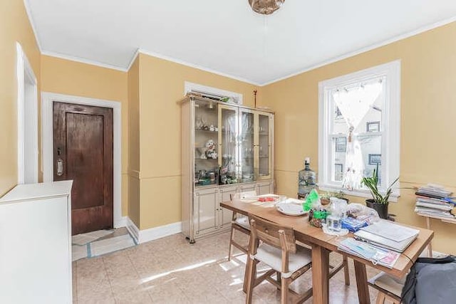 dining room with crown molding, baseboards, and light tile patterned floors