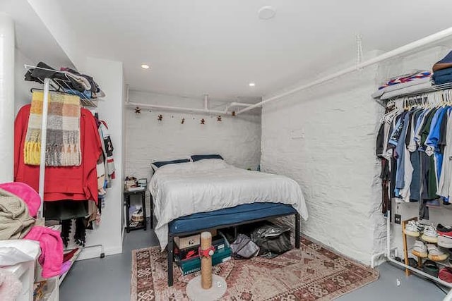 bedroom featuring concrete flooring