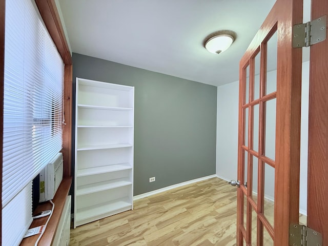 spare room with light wood-type flooring and baseboards