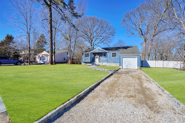 view of front of house with driveway, a garage, fence, and a front yard