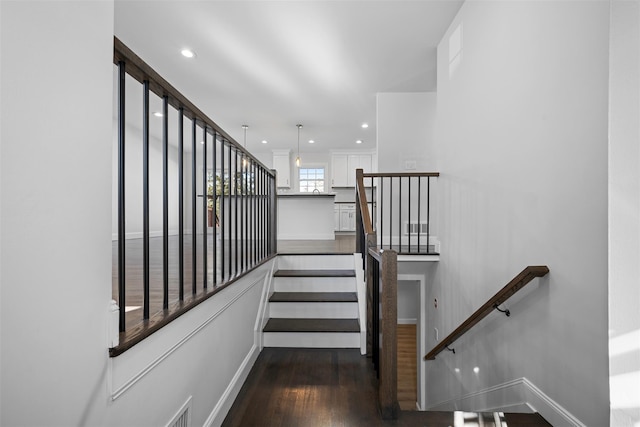 stairs with recessed lighting, visible vents, baseboards, and wood finished floors