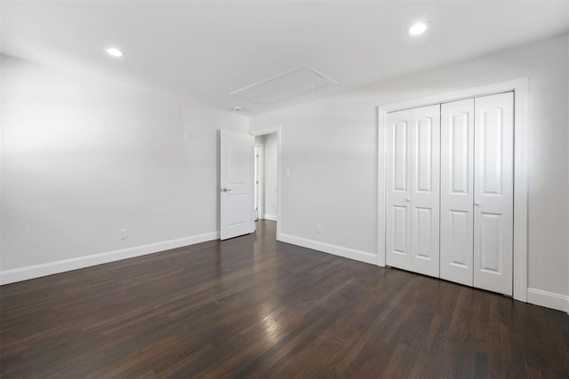 unfurnished bedroom with attic access, recessed lighting, dark wood-style flooring, and baseboards