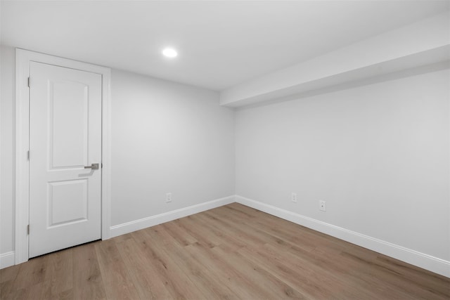 spare room featuring baseboards, recessed lighting, and light wood-style floors