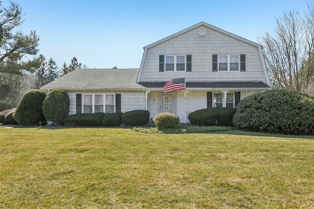 dutch colonial with a gambrel roof and a front yard