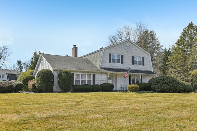 dutch colonial featuring a shingled roof, a front yard, a gambrel roof, and a chimney