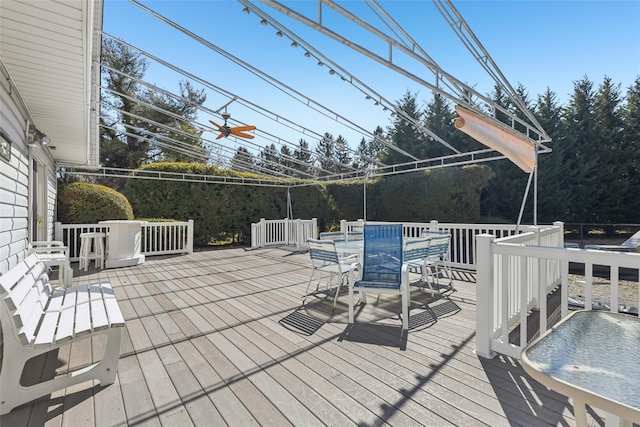 wooden terrace featuring outdoor dining space