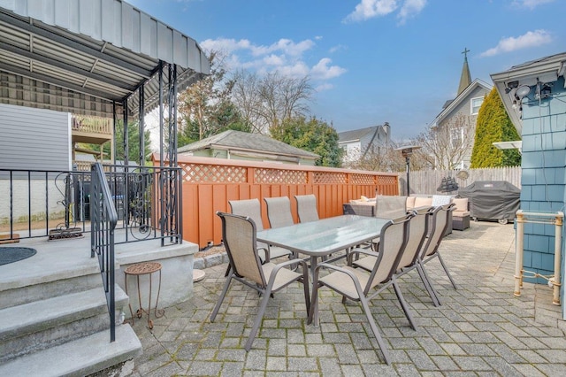 view of patio / terrace with outdoor dining space, fence, and a grill