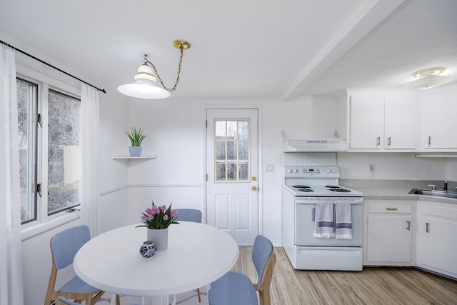 kitchen with electric range, white cabinets, light countertops, open shelves, and decorative light fixtures