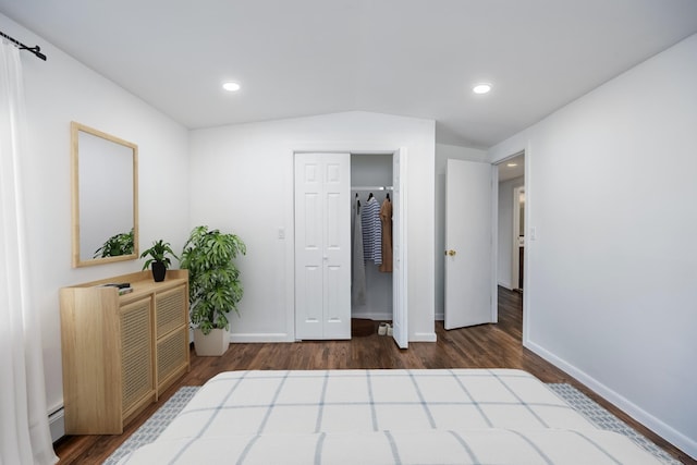 bedroom with dark wood-type flooring, baseboards, and baseboard heating