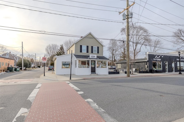 view of road featuring curbs, traffic signs, and sidewalks