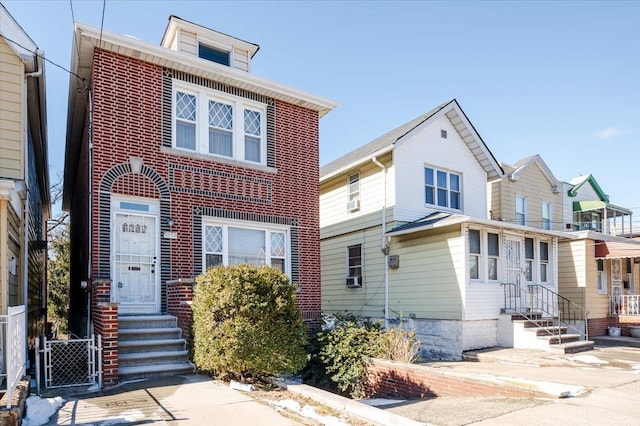 traditional style home featuring entry steps and brick siding