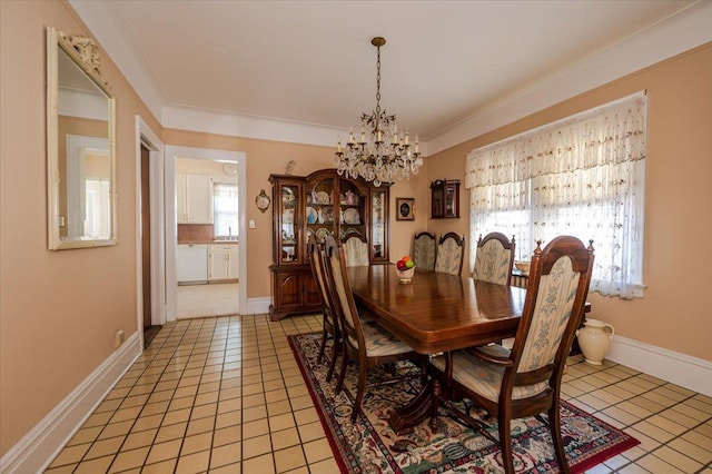 dining space with baseboards, ornamental molding, light tile patterned flooring, and a notable chandelier