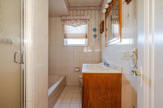 full bath with tile walls, tile patterned flooring, vanity, and toilet