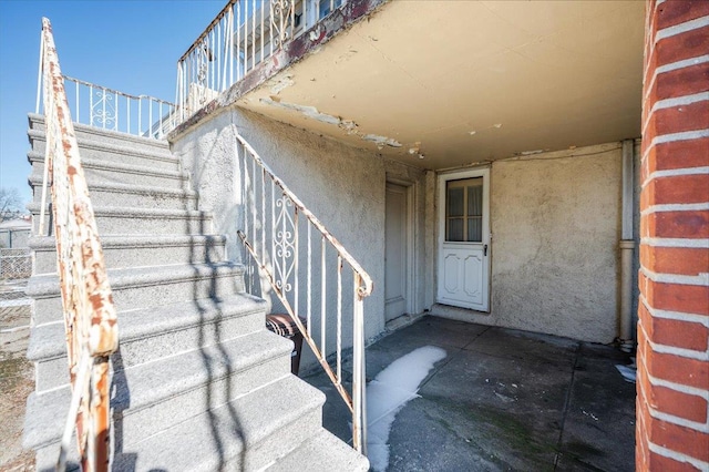 entrance to property featuring stucco siding